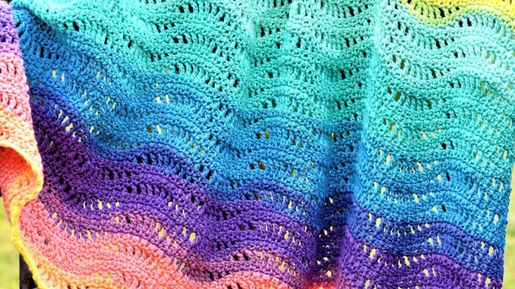 A lacy, wavy gradient baby blanket.