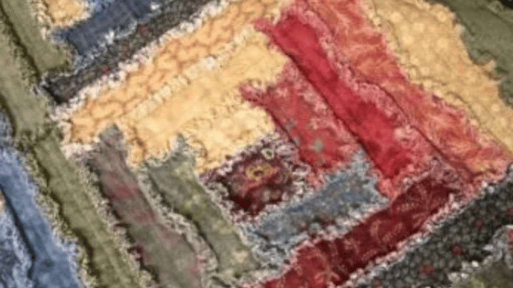 log cabin rag quilt with brown, reds and cream colored fabric