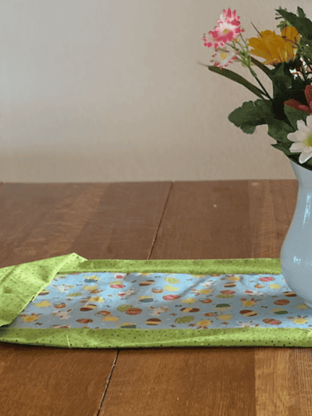 easter table runner with green poka dotted fabric as border and easter fabrric in center