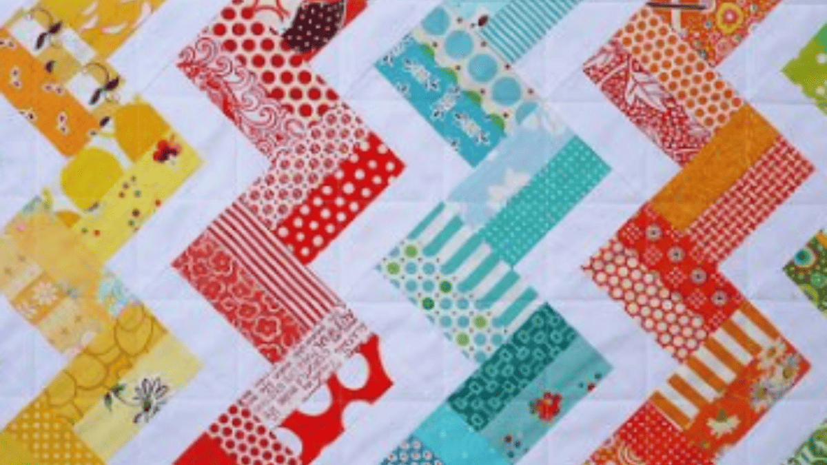 zig zag rail fence quilt with bright colors of red, blue, yellow, pinks