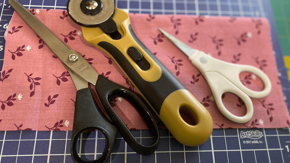 3 scissors on a fabric showing best scissors for cutting fabric