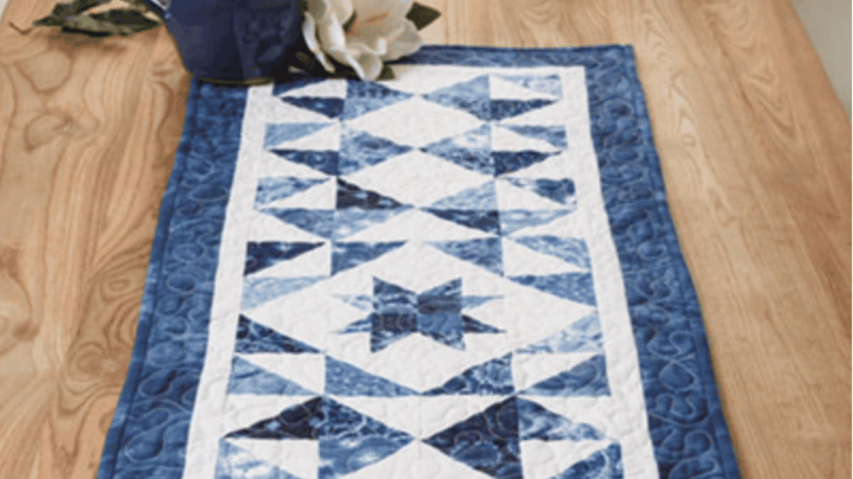 blue and white table topper on a table