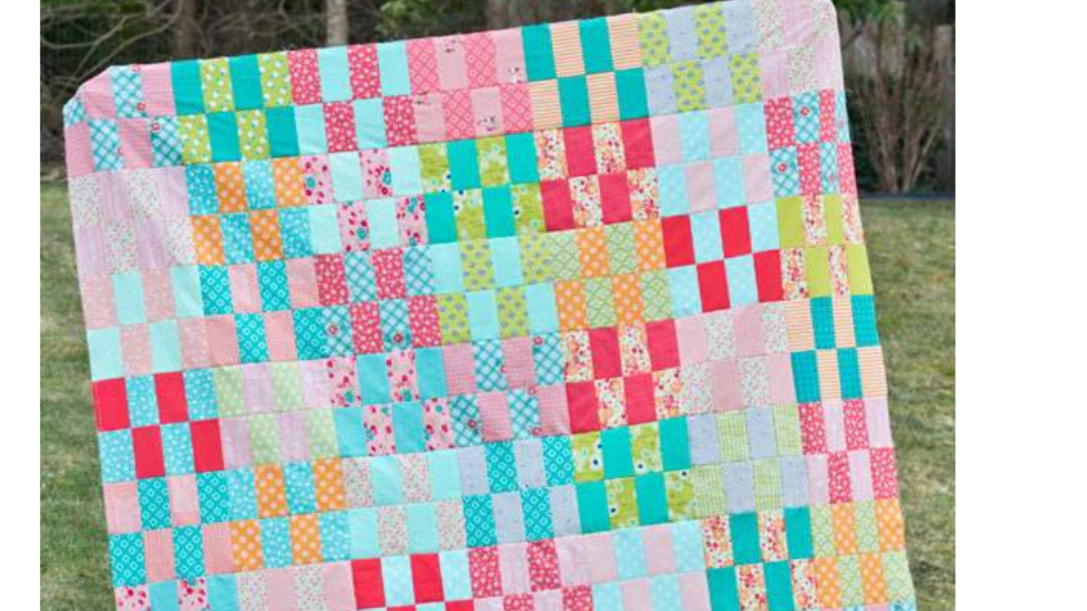 jelly roll stash fabrics cut into equal bars and made into a quilt