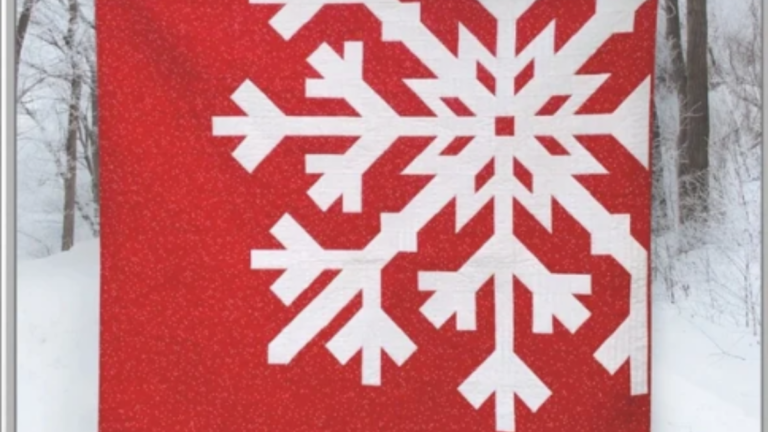 red quilt with white snowflake