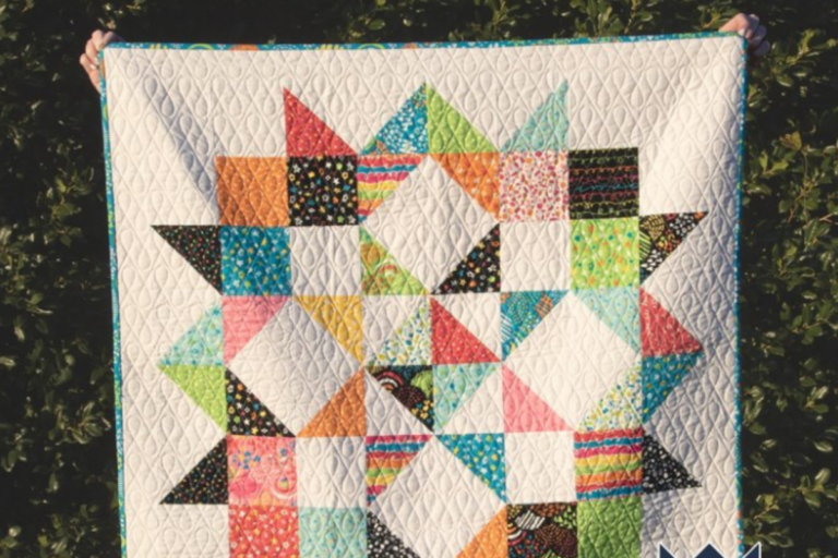 baby quilt with brightly colored fabric