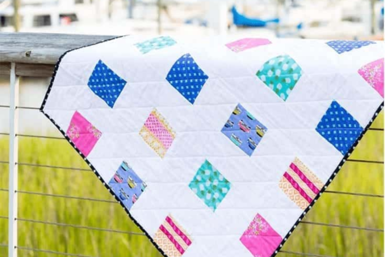 Foursquare baby quilt in Blue Springs pinks